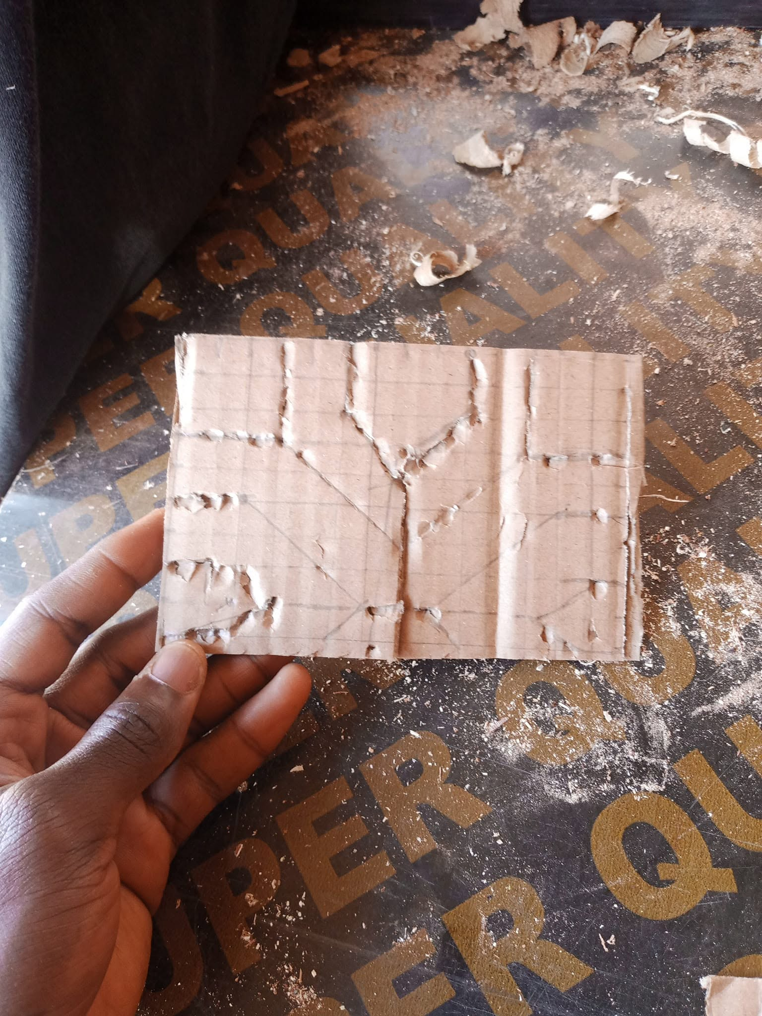 Hand-held cut template showing the proposed central geometry for a custom upholstered bed headboard