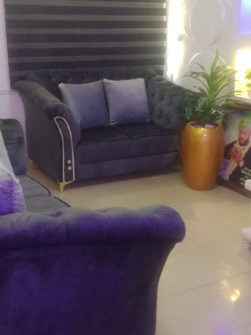 Black upholstered seating suite positioned in an interior