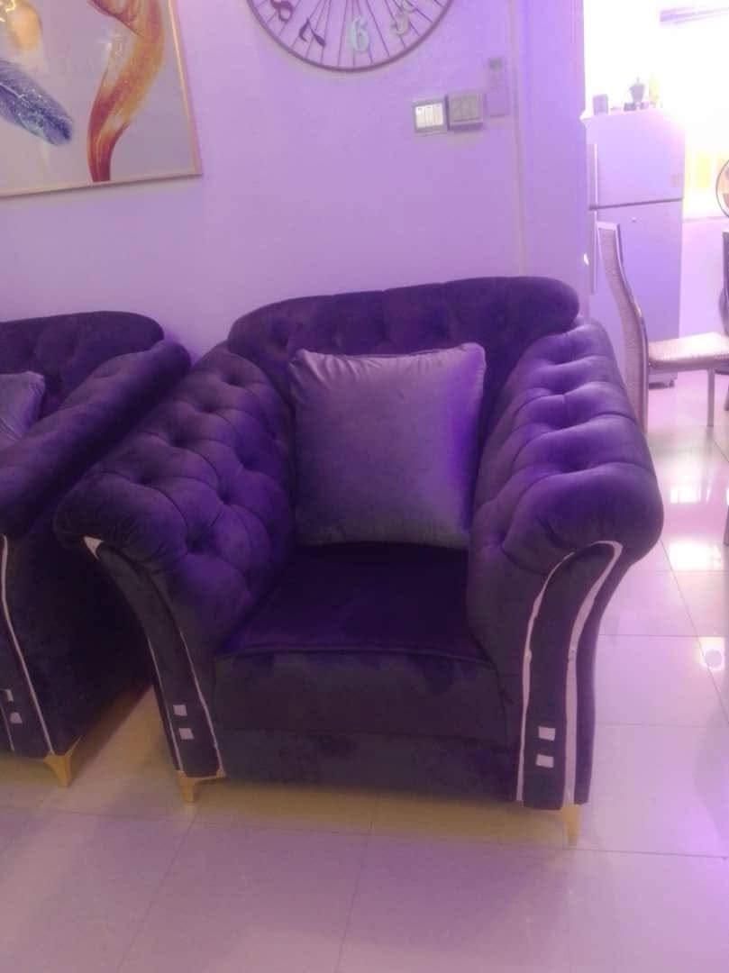 Black upholstered armchair shown in an interior