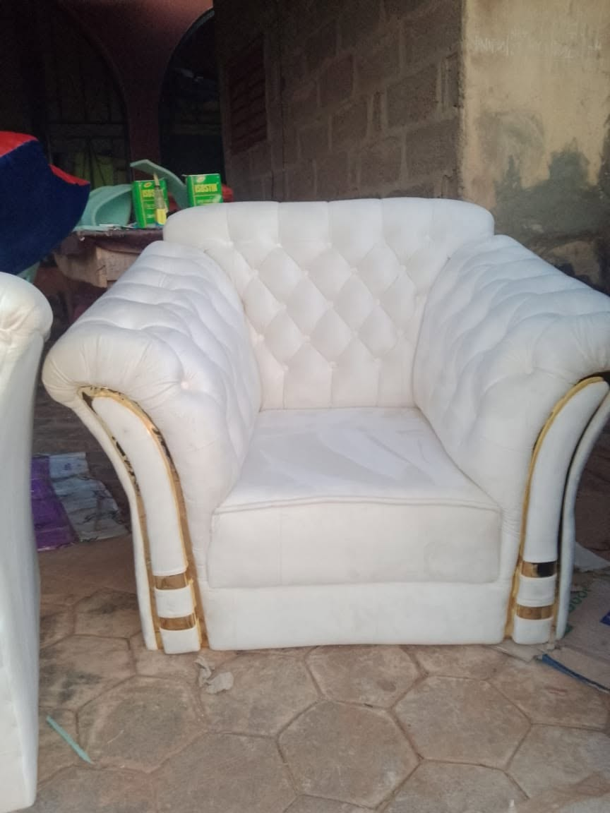 White and gold upholstered armchair photographed at the workshop