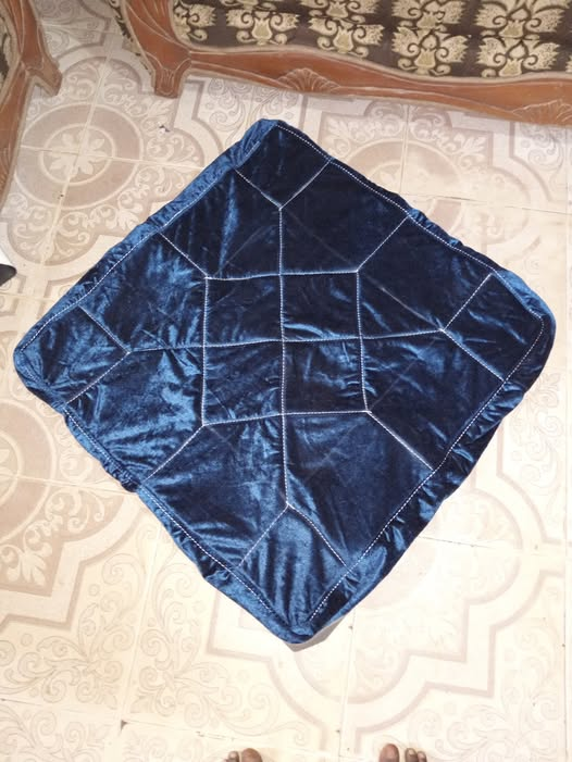 Geometric cushion detail shown with a navy upholstered armchair