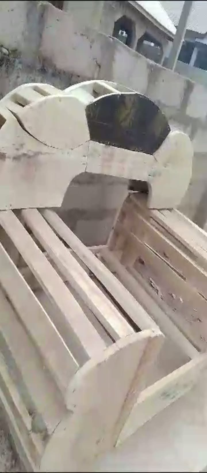 Cream and black chair frame with open wooden seat slats at the workshop