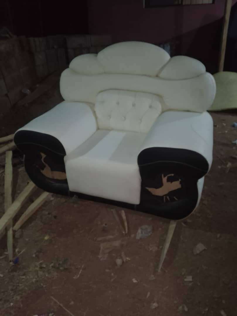 Cream and black ornate armchair photographed during an upholstery stage at the workshop