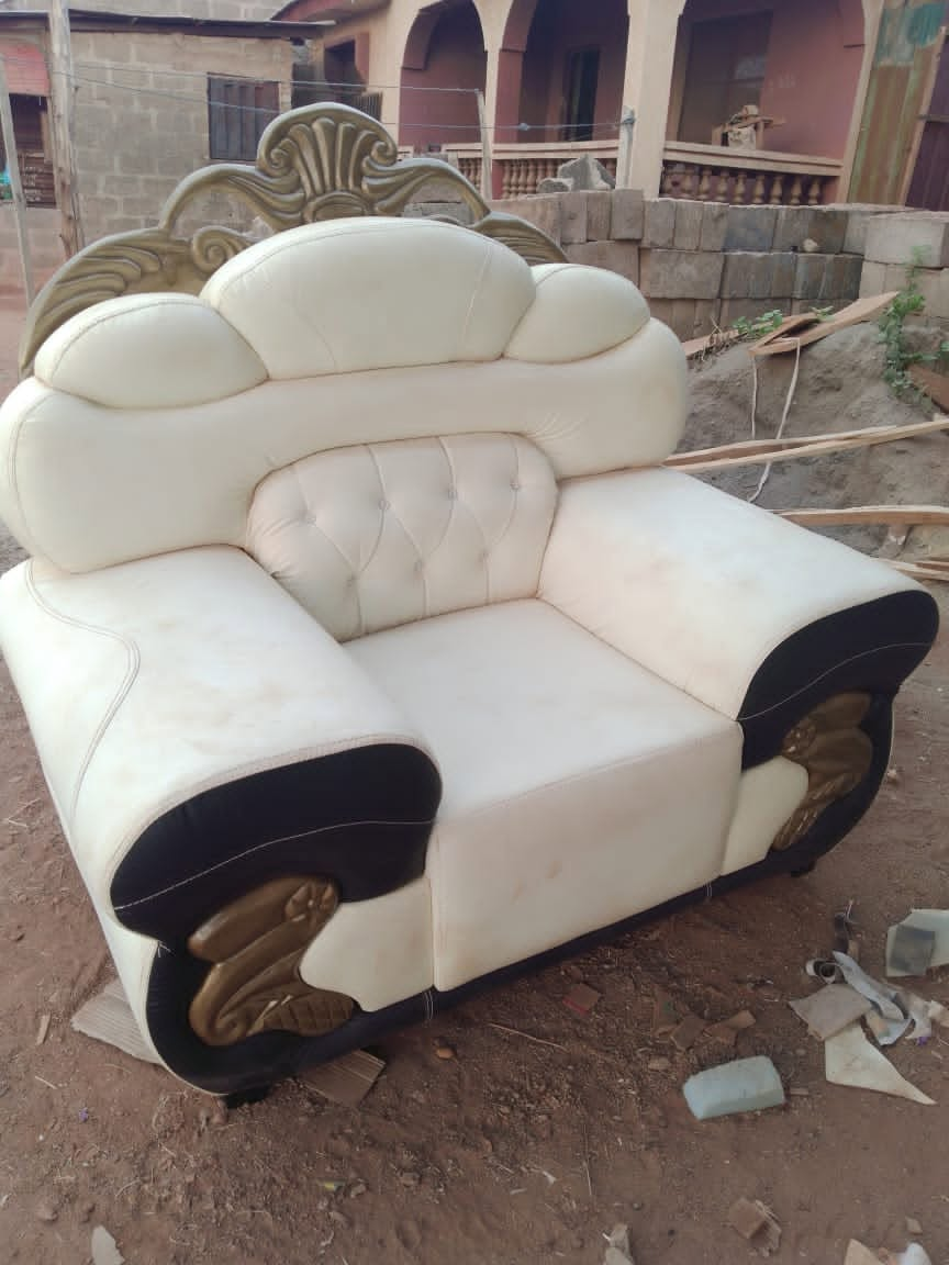 Finished cream and black ornate armchair with carved gold detail, shown from the front