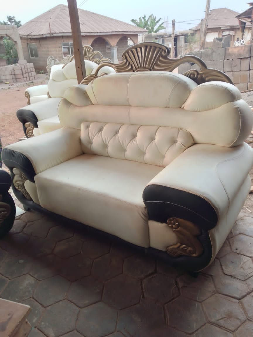 Finished cream and black ornate armchair with carved gold detail, shown at an angle