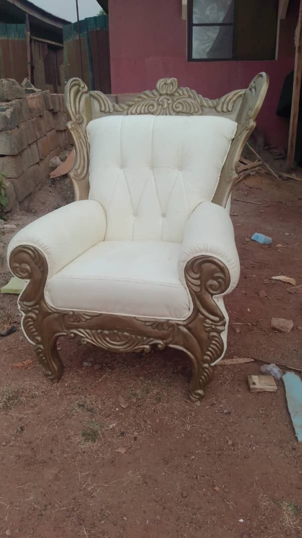 Finished cream upholstered armchair with a gold carved wooden frame