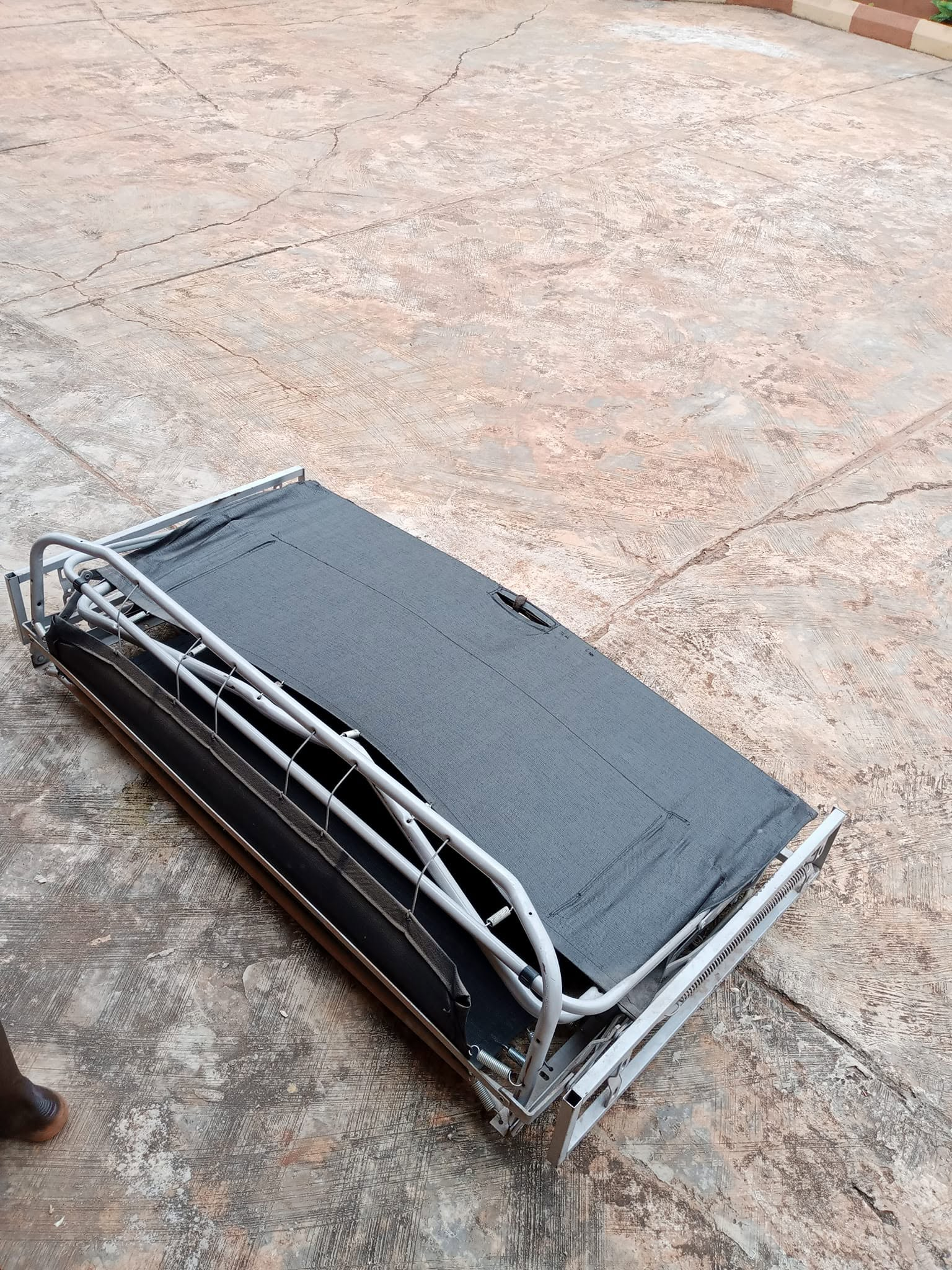 Metal pull-out sofa-bed mechanism photographed on the ground before installation